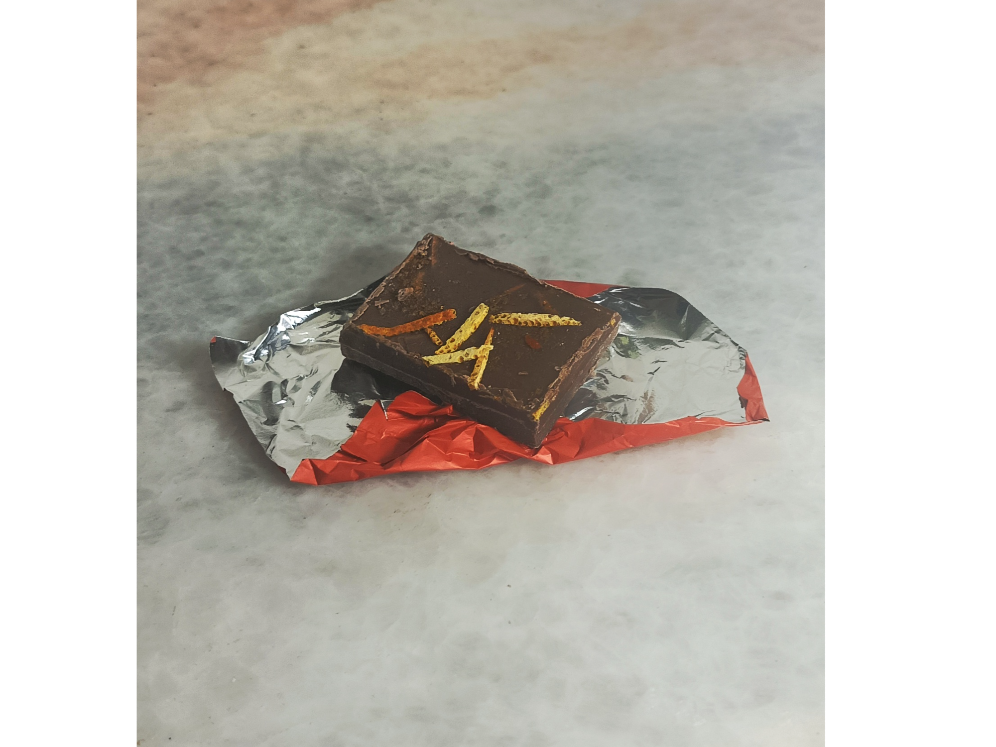 Bocadito de Maracuyá y naranja con chocolate c/leche