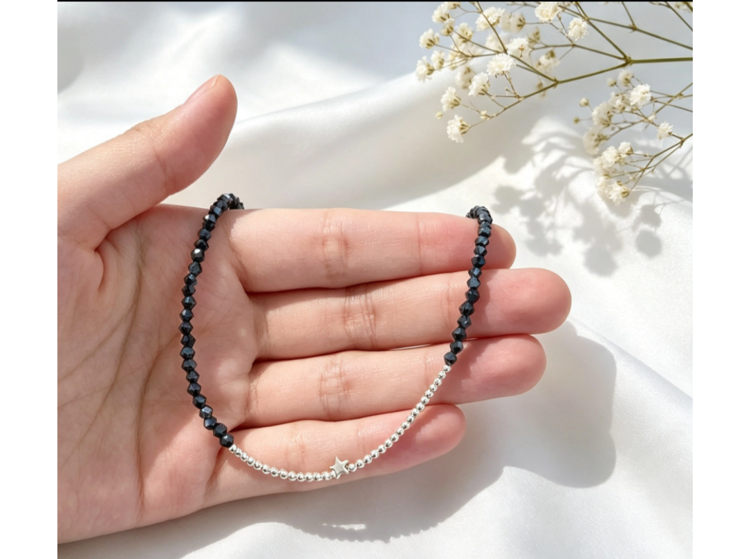 Cristal bicono negro azulado con dije estrella CHO003