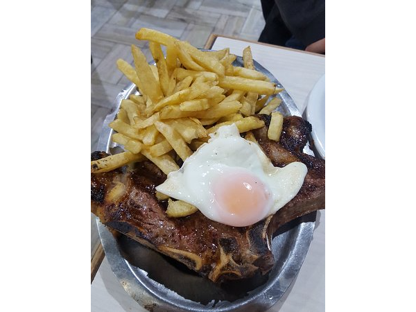Costeleta de vaca con huevo frito