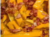 Papas fritas con cheddar y panceta SIN VERDEO