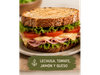 Sándwich con pan de masa madre relleno con: lechuga, tomate, jamón y queso
