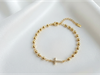 Pulsera dorada CM con dije Cruz con cristales baño 14k