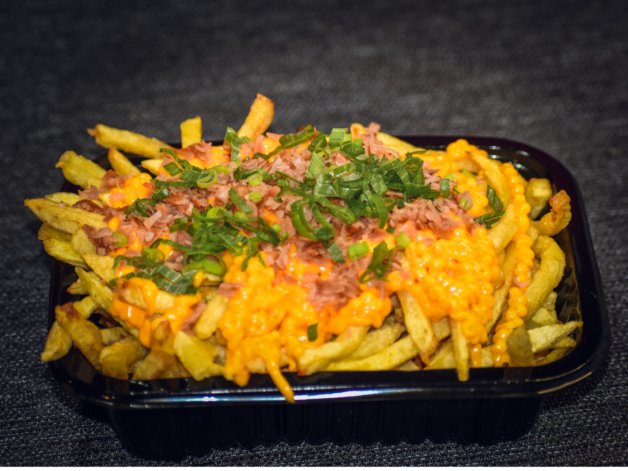 Papas con cheddar panceta y verdeo