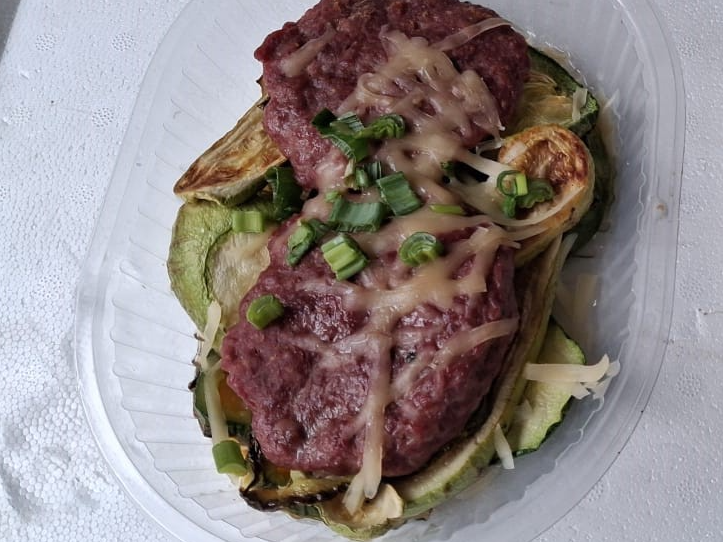 1. Hamburguesas sobre colchón de zucchinis y zapallitos con crema de verdeo y queso rallado.