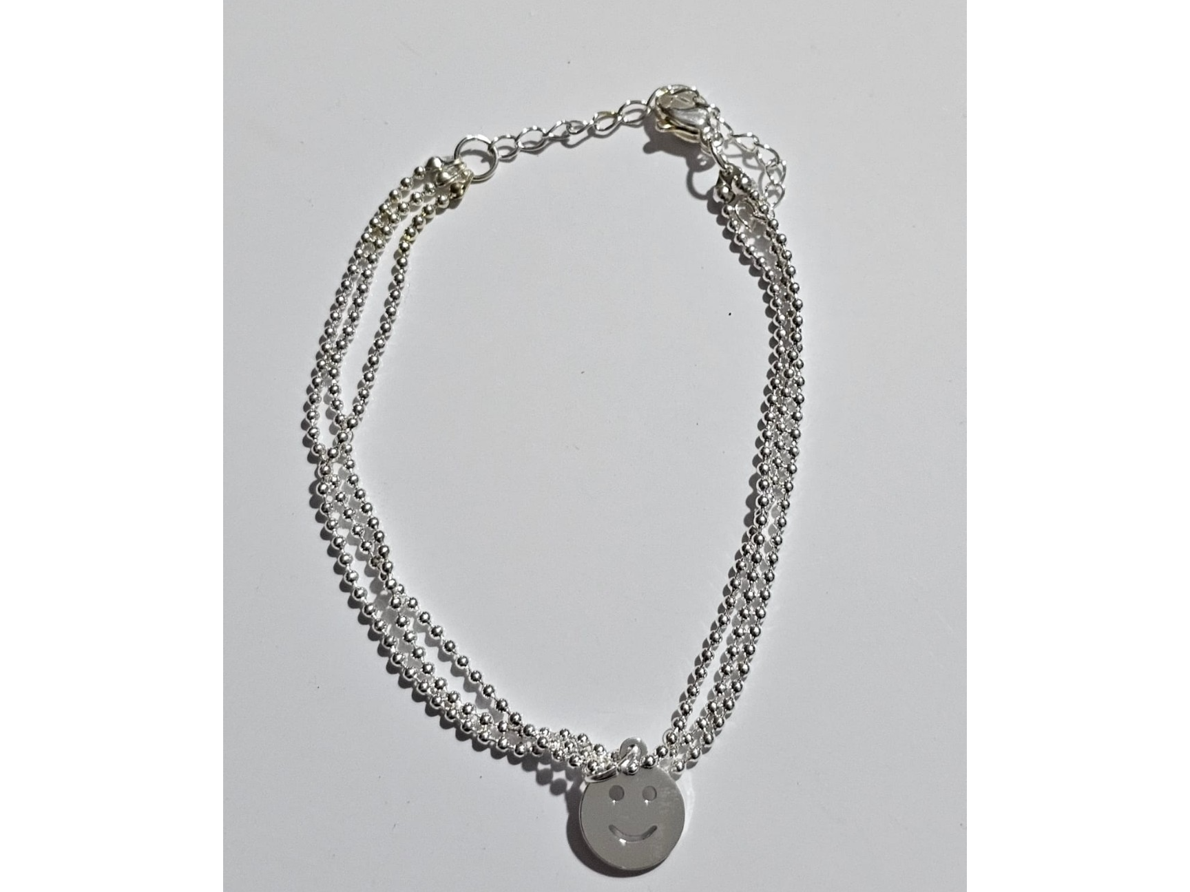 Pulsera triple con carita